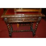 An early 20th century heavily carved oak and gilt tooled red leather inset single drawer side table,