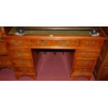 A reproduction yew wood and gilt tooled green leather inset twin pedestal writing desk, w.122cm
