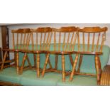 A set of four modern pine stick back kitchen chairs