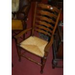 A contemporary Lancashire oak ladderback rush seat single elbow chair, together with a 19th