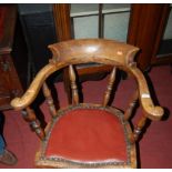 An early 20th century elm and fruitwood tub captain's chair