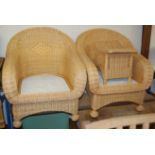 A contemporary wicker conservatory suite comprising two seater sofa, pair of armchairs, footstool