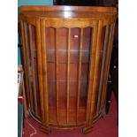 A 1930s figured walnut demi-lune single door glazed china display cabinet, w.91cm