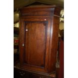 A George III oak and mahogany crossbanded single door hanging corner cupboard