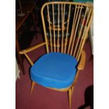 An Ercol lght elm stickback open armchair