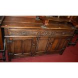 A 17th century style joined and floral relief carved oak dresser base, having three frieze drawers