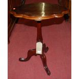 A 19th century mahogany shaped top fixed pedestal tripod occasional table