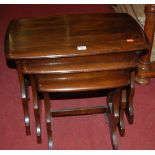 An Ercol dark elm nest of three occasional tables, the largest width 57cm