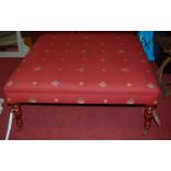 A large contemporary upholstered square foot stool raised on turned beech supports, width 100cm