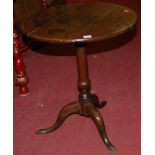 A 19th century plank top oak circular pedestal tripod table, dia. 57cm