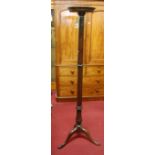 An early 20th century mahogany cluster column plant-stand, having acanthus leaf carved detail and on