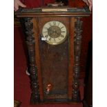 An early 20th century walnut Vienna drop trunk wall clock