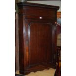 A George III oak single door hanging corner cupboard; together with two similar early 19th century