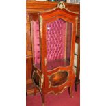 A Louis XV style walnut and gilt metal mounted single door display cabinet, having arched top over