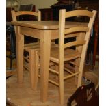 A small modern pine round cornerd kitchen table, together with two beech ladderback panelled seat