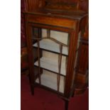 An Edwardian walnut and polychrome decorated single door glazed china display cabinet, width 59cm