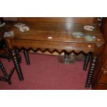 A Victorian oak ledgeback hall table, having single end drawer and raised on bobbin turned supports,