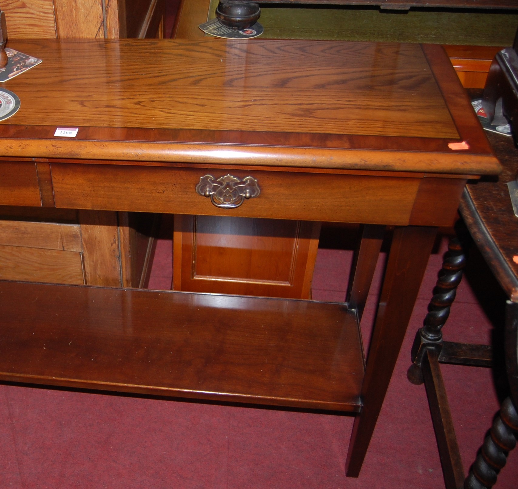 A contemporary oak and mahogany two drawer hall table, raised on square tapering supports to