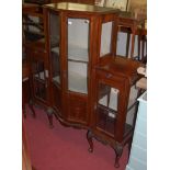 An Edwardian mahogany serpentine front china display cabinet, the twin central doors flanked by