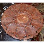 An Eastern relief carved teak circular folding occasional table, together with a hinge top music