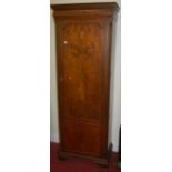 An early 20th century walnut and figured walnut single door hallrobe, on ogee bracket supports, w.