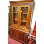 A Victorian mahogany and flame mahogany bookcase cupboard, having twin glazed upper doors, w.107.