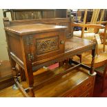 A contemporary Old Charm moulded oak telephone seat, width 93cm