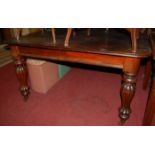 A Victorian mahogany round cornered extending dining table, raised on bulbous reeded supports (