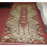 A Caucasian cream ground woollen rug, having a stylised floral ground, 220 x 125cm