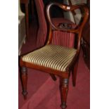 A set of four mid Victorian rosewood balloon back dining chairs, each having striped upholstered