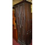 An unusual early 20th century stained and relief carved oak double door narrow side cupboard, w.