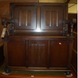 A moulded oak linenfold panelled monks bench, having foldover top to typical hinged boxseat base,