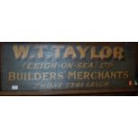 An early 20th century painted oak double-sided shop sign for W.T. Taylor Builders Merchants