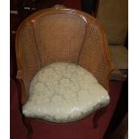 A contemporary French style walnut and double split cane single fauteuil, together with an ash and