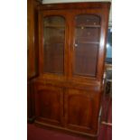 A mid Victorian mahogany round cornered bookcase cupboard, width 126cm