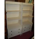 A pair of Regency style painted pine waterfall bookshelves, each with twin long lower drawers, w.