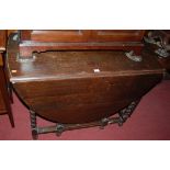 An early 20th century barleytwist oak dropleaf dining table