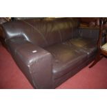 A contemporary chocolate brown leather three seater sofa