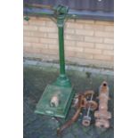 An early 20th century green painted cast iron set of weighing scales, together with a cast iron