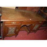 An Edwardian relief carved walnut dressing table, w.142cm