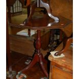 A reproduction mahogany octagonal low pedestal occasional table; together with a pair of piecrust