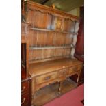 An 18th century style joined oak dresser, having two-tier open plate-rack with small central