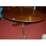 A reproduction mahogany and crossbanded oval pedestal coffee table