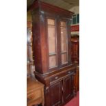 A late Victorian walnut bookcase cupboard