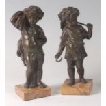 A pair of late 19th century French bronze cherub figures gathering the harvest, each on veined