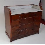 An early Victorian mahogany washstand, having a white marble inset three quarter gallery over two