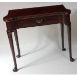 An early George III mahogany card table, the fold-over top having proud corners and dished counter