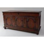 A circa 1700 joined oak three panel coffer, having rosette blind carved frieze, raised on