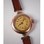 An early 20th century lady's 9ct gold Rolex wristwatch, the round dial with black Arabic numerals,