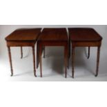 An antique mahogany double D-end dining table, the ends on ring turned tapering supports, the